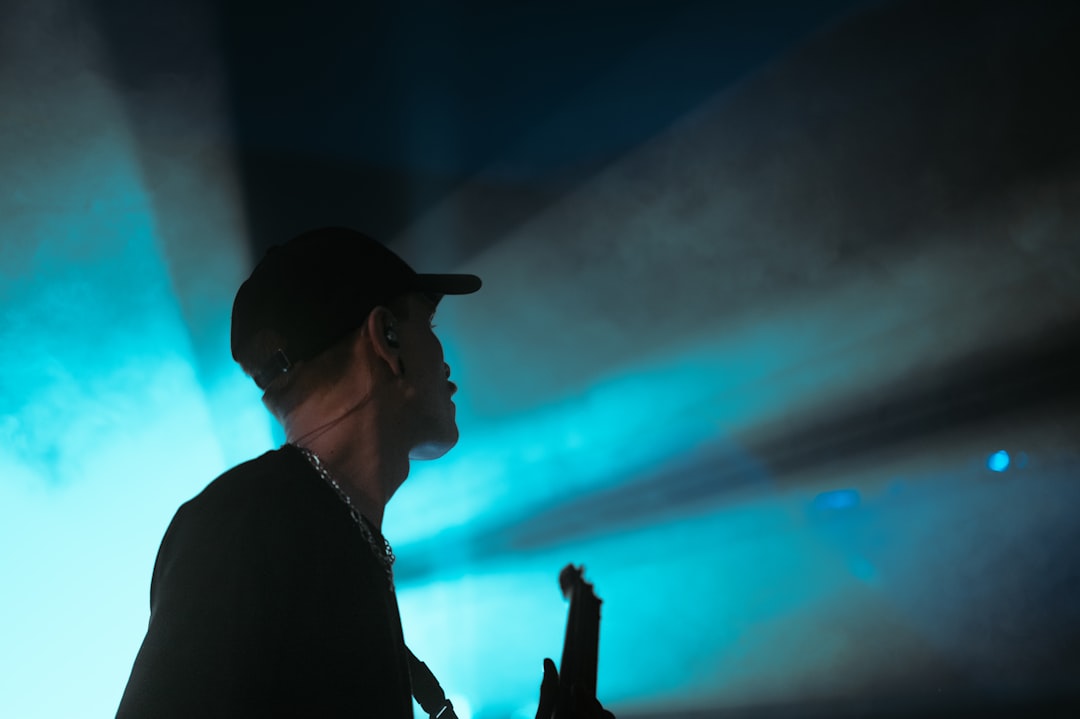 A man standing in front of a blue light