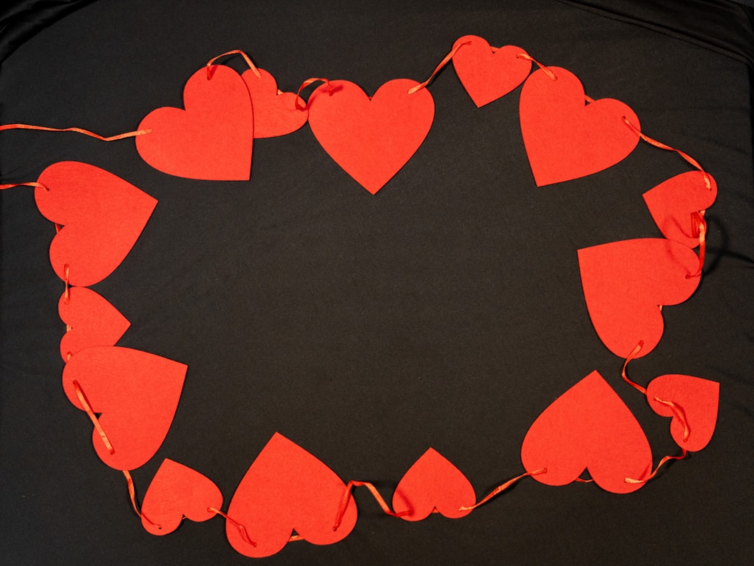 a bunch of red hearts on a black background